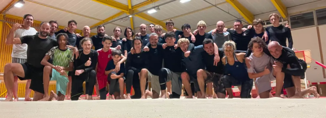 Pratiquants Amazonia, adultes et adolescents, réunis en tenue no-gi sur le tatami à la fin d’une séance de grappling